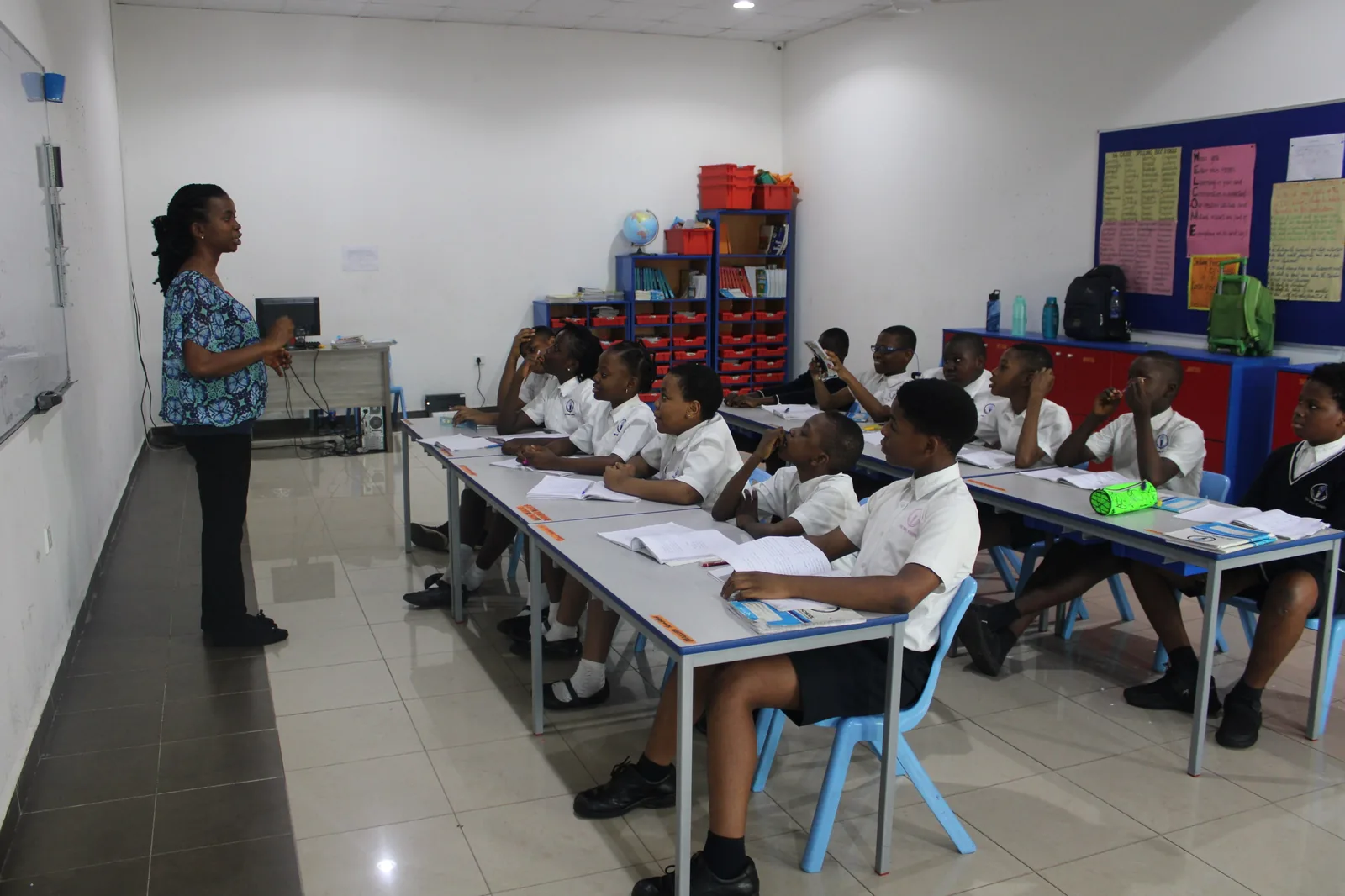 Teacher guiding students in class at The Wins School