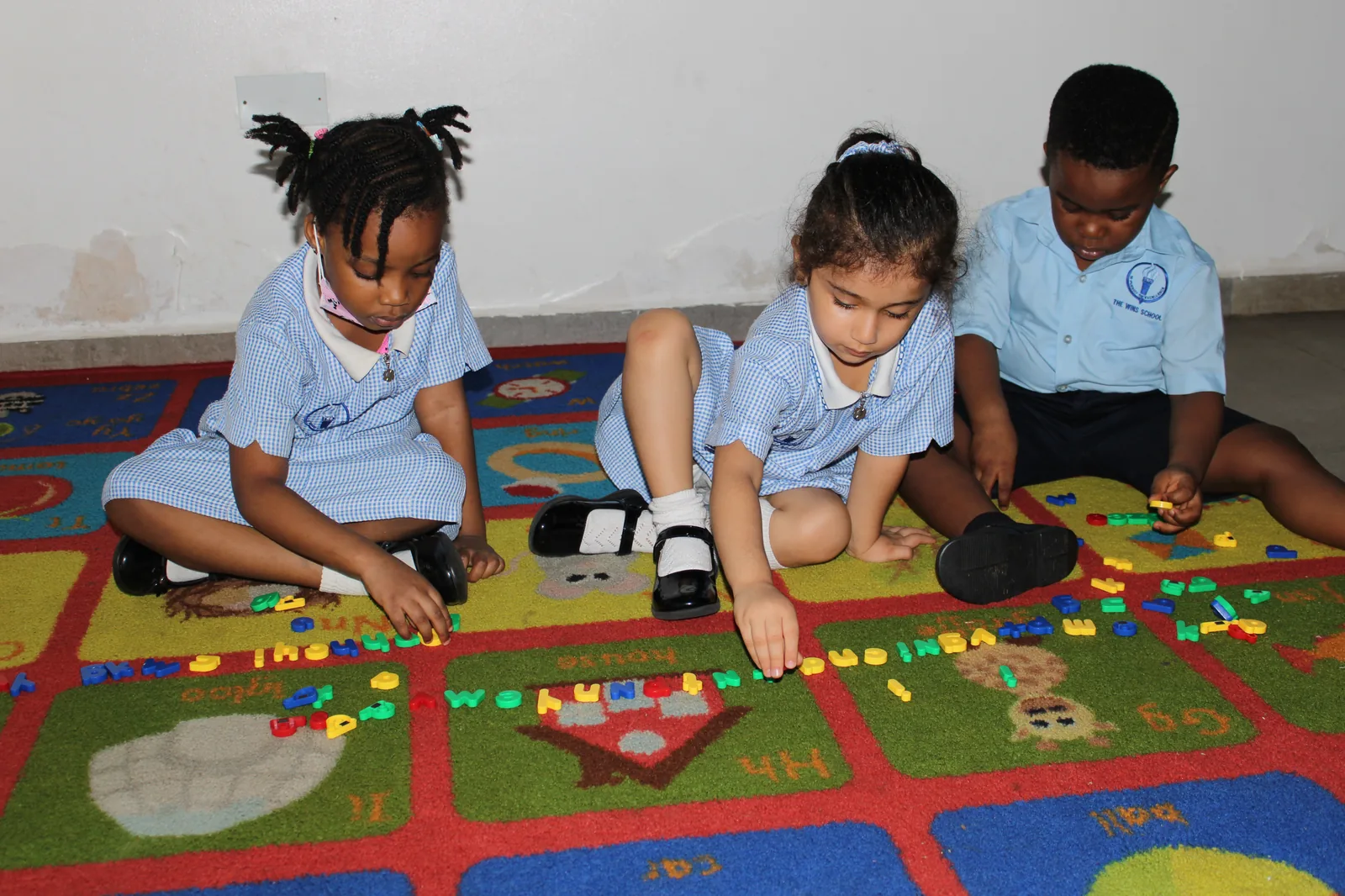 Young learners working with classroom materials